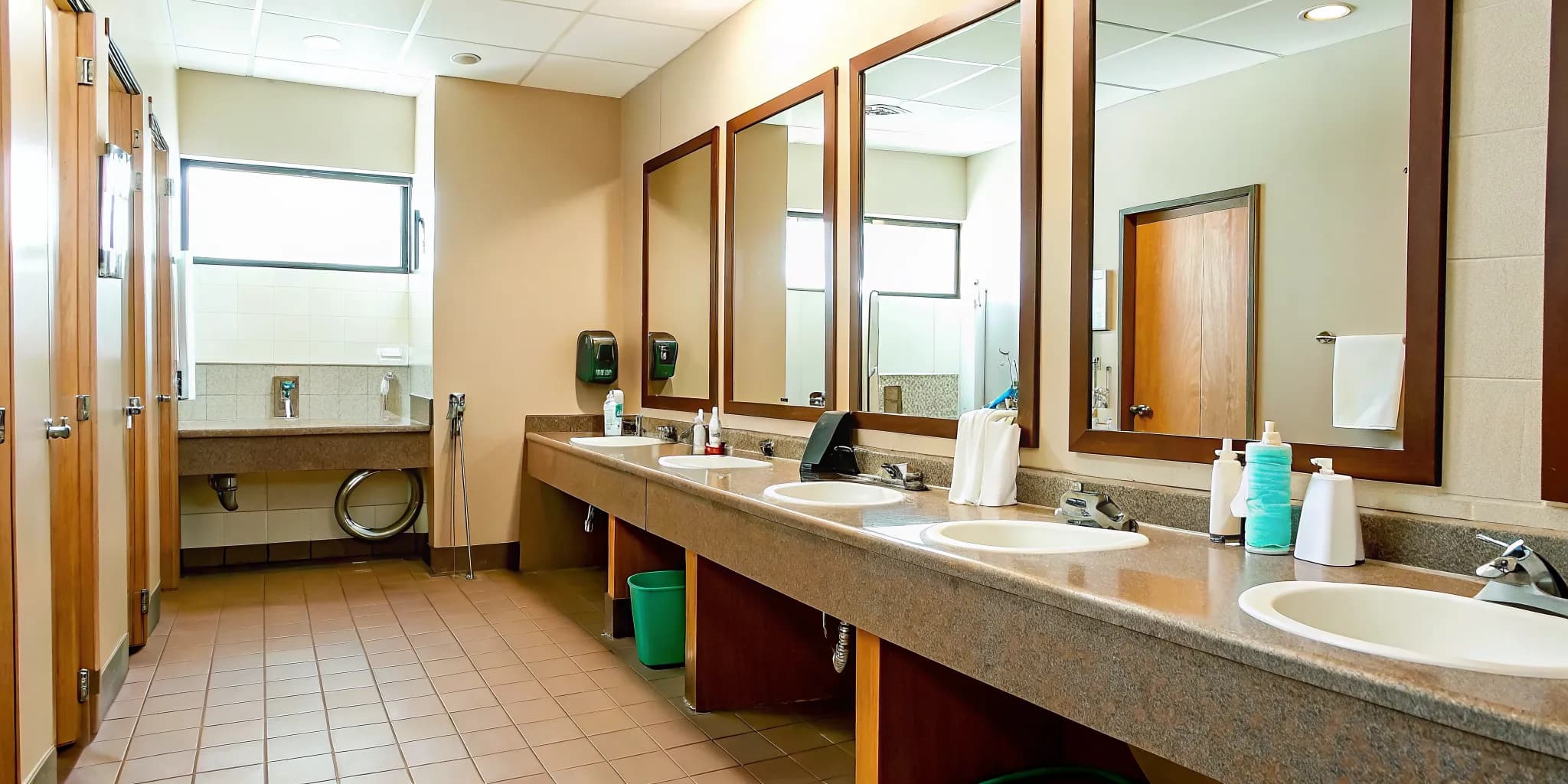 Clean commercial restroom with gleaming sinks and mirrors in a Norman office